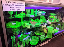 The amount of radiation that would be given off by the small amounts of uranium seeded in the glass (remember, glass is basically melted sand, so you just mix some uranium into the sand, melt it down into glass) would be negligible to cause harmful effects. I Came Across A Shop Selling Vaseline Glass That Glows Under Uv Light Because It Contains Uranium Mildlyinteresting