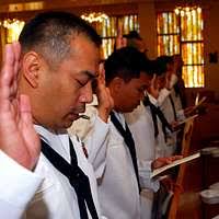 Culinary Specialist 1st Class Joshua Conrad, a recruiter at Navy Recruiting  District St. Louis, speaks with Delayed Entry Program participants prior to  entering Busch Stadium for a joint oath of enlistment ceremony. -