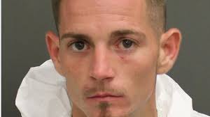 Man arrested after woman found shot and killed at motel near OIA