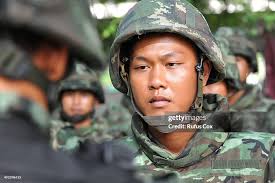 A Thai army officer briefs soldiers standing guard outside the... News  Photo