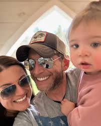 She works like the devil and cries when she prays Believes a good glass of  wine can fix anything Holds it all together, hell, I'm so amazed How she  feeds the baby,