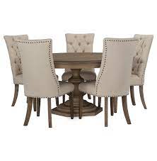 A wicker table set with a glass table top, for example, adds a little transitional charm to the room, while a counter height table with elevated stools is perfect for casual dining. Round Dining Table With Upholstered Chairs G1609710053n00 1200 1200 Round Dining Room Table Round Dining Room Round Dining Room Sets