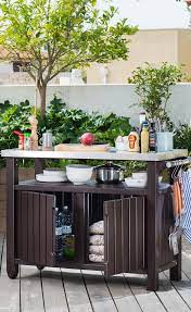 It includes a grill, maybe a pizza oven, a sink, some storage space and cooking countertops. Bar Table Outdoor Kitchen Outdoor Kitchen Design Diy Outdoor Kitchen