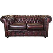 Vintage chesterfield sofa in brown tufted leather, round wood bun feet and brass nailhead trim. Chesterfield Antique Oxblood Red Genuine Leather Two Seater Sofa
