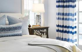 Designer curtains are a great addition to any room that needs a little extra pop! White Padded Headboard With Blue Striped Curtains Transitional Bedroom
