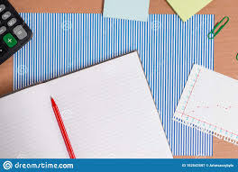 cardboard desk with a striped blue sheet notebook paper and