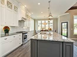 White Kitchen Cabinetry With Grey Accent Island Chrome Hardware Grey Kitchen Cabinets Grey Granite Countertops Light Grey Kitchen Cabinets