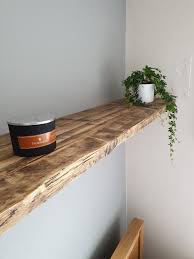 It has a round metal frame that supports three small solid wood shelves. Extra Long Double Reclaimed Scaffold Board Shelf Floating Shelves Living Room Scaffold Board Shelves Reclaimed Wood Shelves