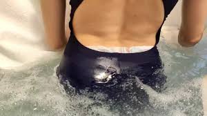 Girl messing her diaper under swimsuit at jacuzzi. - ThisVid.com