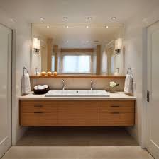 Brass faucets and hardware add metallic glam to the space. Modern Bathroom Vanity Lighting Ideas Trendecors