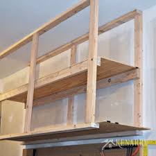 Hanging bikes from ceiling joists using scrap wood and bike hooks. Diy Garage Storage Ceiling Mounted Shelves Giveaway