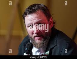 Former Chicago White Sox pitcher Mark Buehrle, left, is hugged by his  family, wife Jamie, top, daughter Brooklyn, and son Braden after his No. 56  was retired during ceremonies before a baseball