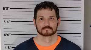 Inmate facing strangulation, assault charges