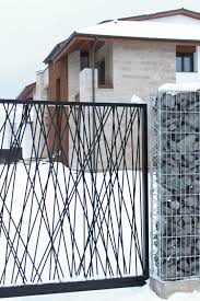 The Architecture Of This Private House Is A Synthesis Of Natural Materials Stone Wood And Simple Geometri House Gate Design Architecture Metal Garden Gates