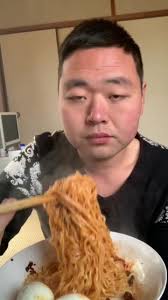 Chinese Boy Enjoying Noodles and Boiled Eggs