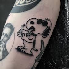 This tattoo consists of snoopy and charlie hugging each other, tatted in colored ink with the appropriate shading and contouring details. Snoopy Archives Studio Xiii Gallery