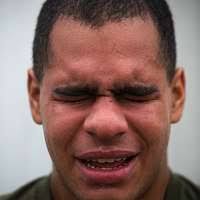 Cpl. Aaron Atwood poses for a photograph holding his