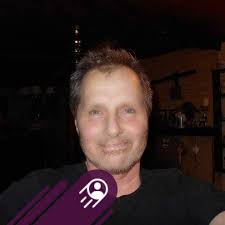 Bruce Gamble stops Gary Bergman in a hockey game