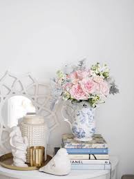 Retrieve the package beside the body of water. Fresh Flowers In The Entryway Fancy Girl Designs