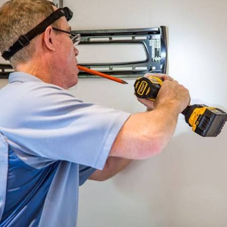 Bracket expert adjusting and fitting tilting TV mounting system on brick wall in BR7