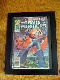 The cheap $1 dollar store comic book frame hack, using a document cert frame. For A While Now I Have Been Wanting To Find A Way To Show Off My Comic Book Collection In My Office I Had Done Comic Book Display Comic Book Rooms