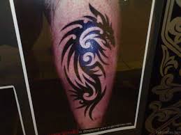 Girls accentuate their sexiness and being cool by displaying tattoos on their thighs, while boys project machismo and angst with tattoos decorating their lower leg, preferred spot by men. Dragon Tribal Leg Tattoos For Men