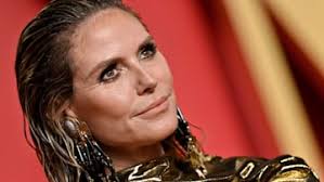 Heidi Klum, 50, is a mermaid goddess in super cinched dress with 70s hair