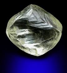 An Uncut Diamond Shows Its Own Natural Beauty With A Classic Dodecaherdral Shape From South Africa Gems And Minerals Stones And Crystals Rocks And Minerals