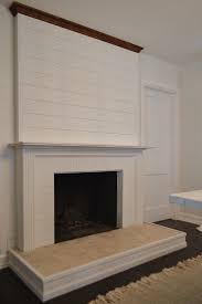 Wood plank wall with narrow mantle, long narrow fire box raised from floor. How To Install Shiplap Above A Fireplace Fox Hollow Cottage
