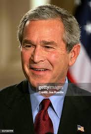 U.S. President George W. Bush laughs ...
