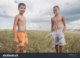 Any of these 25 great long haircuts for teenage boys is a great choice for a teenage boy looking for something different. Young Boys Standing In A Field Boys In Shorts Royalty Free Stock Photo 517265245 Avopix Com