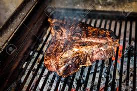 Let the coals burn down until there is little to no active fire, but they are still quite hot (you can hold your hand about 1 foot above the coals). Grilling Big T Bone Steak On Natural Charcoal Barbecue Grill Preparing A Big Steak On Natural Firewood Bbq In Outside Fireplace Grill Marks On Delicious Barbecue Grill Steak House Steak Stock Photo