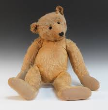 A mohair wood straw filled hump back growler teddy bear, possibly Steiff,  with black glass boot butt