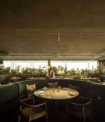 biophilic lisbon restaurant seen invites diners to an art deco forest the spaces in 2021 lisbon restaurant tivoli hotel urban planning