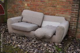 Customer photographing old sofa for TFP Furniture Exchange assessment in Mauritius