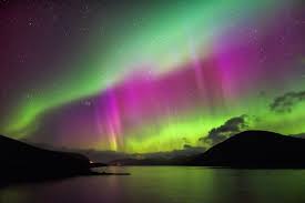 Colorful northern lights spiral in a iceland beach. The Northern Lights And 7 Of The Best Places To View Them Highland Titles