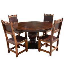 The smooth extending mechanism in the dining table will seat 4 to 6 people and the black wood veneer is easy to clean and looks modern. Santa Ana Round Kitchen Dining Table Set With Leather Back Chairs