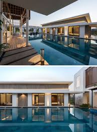 The property boasts a luxurious swimming pool surrounded by healthy trees, plants and flowers. This House Was Designed To Wrap Around A Large Swimming Pool