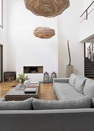 Walls covered in a natural wallpaper and terracotta tiles made this entire space feel heavy, while overgrown landscaping obscured the ocean's breeze. Living Room With Void House By The Water