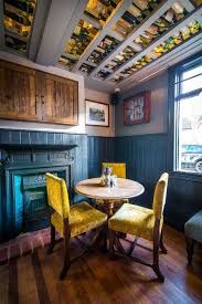 Interior Decor Inspiration Mustard Velvet Chairs Blue Tiled Fireplace Upcycled Wine Bottle Ceiling Ideas In Tradi Pub Interior Pub Interior Design Pub Decor