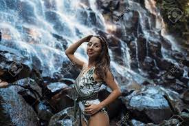 Beautiful Sexy Girl Under Kanto Lampo Waterfall In Indonesia. Фотография,  картинки, изображения и сток-фотография без роялти. Image 140417311