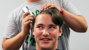 Riley Haynes hair is falling out due to cancer treatments. His friends  shaved their heads in solidarity.