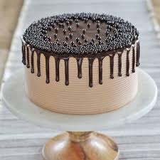 Soft chocolate cake roll filled with light and fluffy frosting with folded mini marshmallows, drizzled with chocolate syrup and topped with more marshmallows. The Ultimate Chocolate Cake Cake By Courtney
