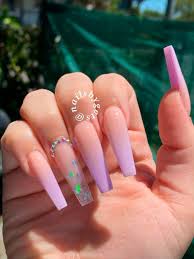 This looks amazing as long acrylic nail designs. Cute Long Coffin Shaped Ombre Purple Acrylic Nails Design With Accent Clear Nail With Glitter Purple Acrylic Nails Pink Acrylic Nails Long Acrylic Nails Coffin