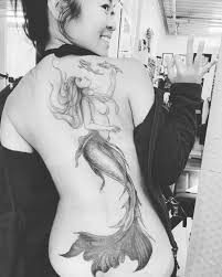 A pretty mermaid tattoo combined with the anchor and flower. 24 The Most Popular Mermaid Tattoo Designs