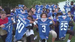 Jacksonville middle school football team gifted new jerseys for the first  time in nearly a decade