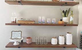 A customer wants a set of bookshelves installed that float across a 6 foot span without brackets. L Bracket And Floating Shelf Bracket Moqqa 4 Pack Shelf Brackets 12 Inch Ideal For Industrial Rustic Heavy Duty Wall Shelf Brackets For Shelves Black Metal Floating Shelves With Hardware Included Shelf