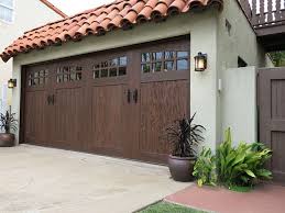 This alder wood garage door has been hand distressed and adorned with rustic iron hardware to give it a flair of the spanish colonial architecture typically found in santa barbara, ca. Super Charge Your Curb Appeal With A Garage Door Makeover