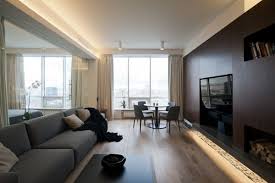There are two living rooms in the apartment, in one is the television (the only one in the house) and in the other is a projector and stereo. An Ultra Modern Moscow Apartment With A Glass Wall Between Bedroom And Living Room