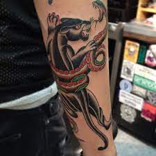Traditional Panther And Snake Tattoo On The Forearm Traditional Tattoo Snake Tattoo Designs Traditional Panther Tattoo